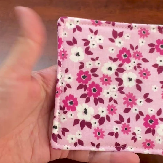 Elevate your space with this playful 100% cotton pink floral coaster. Featuring a vibrant and stylish floral print, this coaster brings a touch of floral and fun to your home. Crafted with an absorbent cotton batting layer inside, it's designed to soak up condensation and protect your furniture from unsightly water rings and spills. Perfect for coffee mugs, glasses, or teacups, this durable and machine-washable coaster is a delightful addition to your kitchen or living room. Elevate your home decor with thi