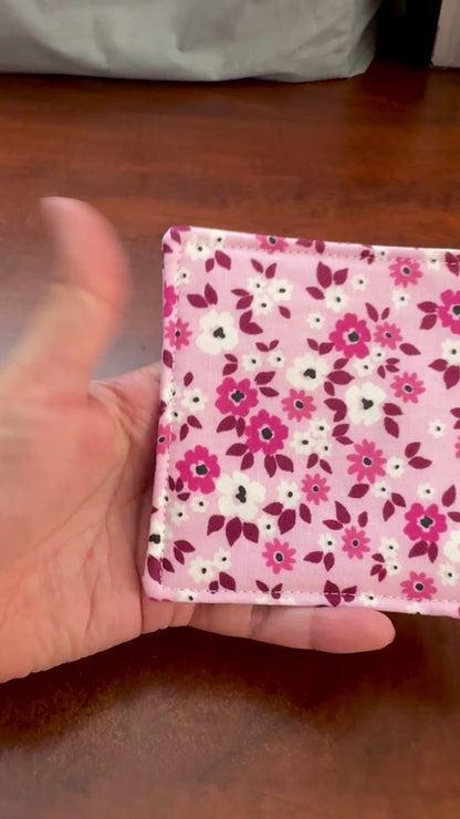 Elevate your space with this playful 100% cotton pink floral coaster. Featuring a vibrant and stylish floral print, this coaster brings a touch of floral and fun to your home. Crafted with an absorbent cotton batting layer inside, it's designed to soak up condensation and protect your furniture from unsightly water rings and spills. Perfect for coffee mugs, glasses, or teacups, this durable and machine-washable coaster is a delightful addition to your kitchen or living room. Elevate your home decor with thi