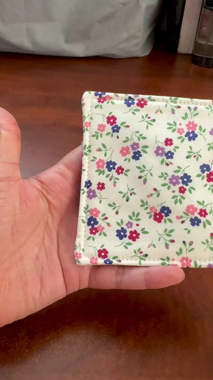 Elevate your space with this playful 100% cotton white floral coaster. Featuring a vibrant and stylish floral print, this coaster brings a touch of floral and fun to your home. Crafted with an absorbent cotton batting layer inside, it's designed to soak up condensation and protect your furniture from unsightly water rings and spills. Perfect for coffee mugs, glasses, or teacups, this durable and machine-washable coaster is a delightful addition to your kitchen or living room. Elevate your home decor with th