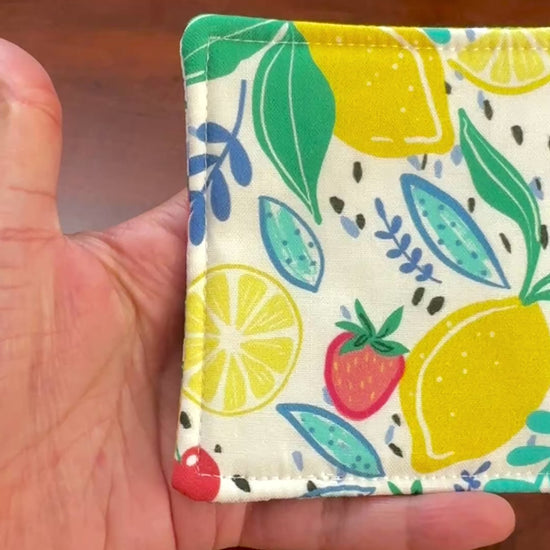 Keep your surfaces safe and stylish with our 100% cotton strawberry and lemon coaster. This charming coaster features a vibrant strawberry and lemon print that adds a touch of fresh, fruity fun to any room. Crafted with an absorbent cotton batting layer inside, it's designed to soak up condensation and protect your furniture from unsightly water rings and spills. Perfect for coffee mugs, glasses, or teacups, this durable and machine-washable coaster is a delightful addition to your kitchen or living room. E