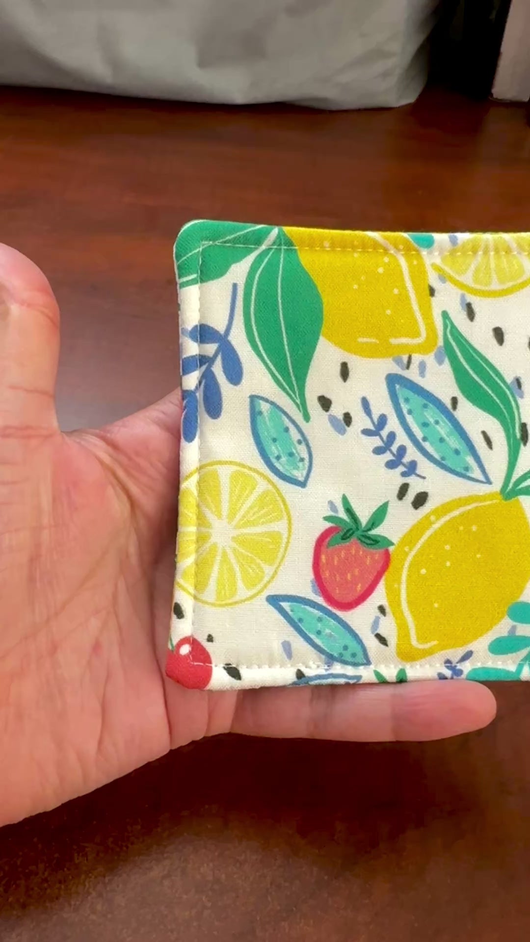 Keep your surfaces safe and stylish with our 100% cotton strawberry and lemon coaster. This charming coaster features a vibrant strawberry and lemon print that adds a touch of fresh, fruity fun to any room. Crafted with an absorbent cotton batting layer inside, it's designed to soak up condensation and protect your furniture from unsightly water rings and spills. Perfect for coffee mugs, glasses, or teacups, this durable and machine-washable coaster is a delightful addition to your kitchen or living room. E