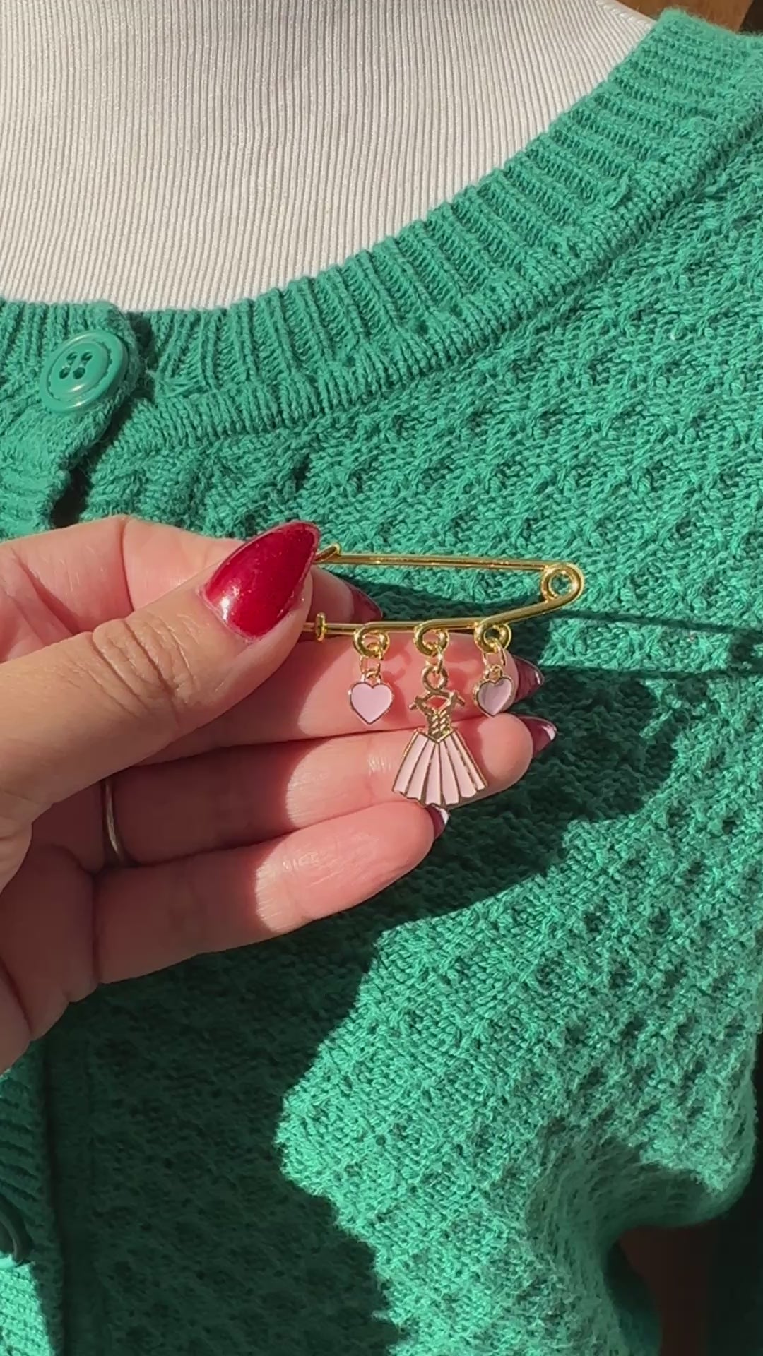 Elevate your Valentines Day or Galentines Day with this adorable gold iron pin brooch featuring pink dress enamel charms. Perfect for adding a touch of love to any outfit.