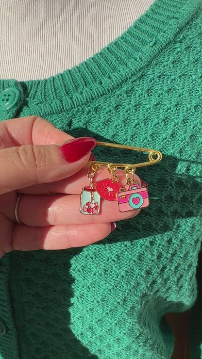 Elevate your Valentines Day or Galentines Day with this adorable gold iron pin brooch featuring coffee, lips, and a camera enamel charms. Perfect for adding a touch of love to any outfit.