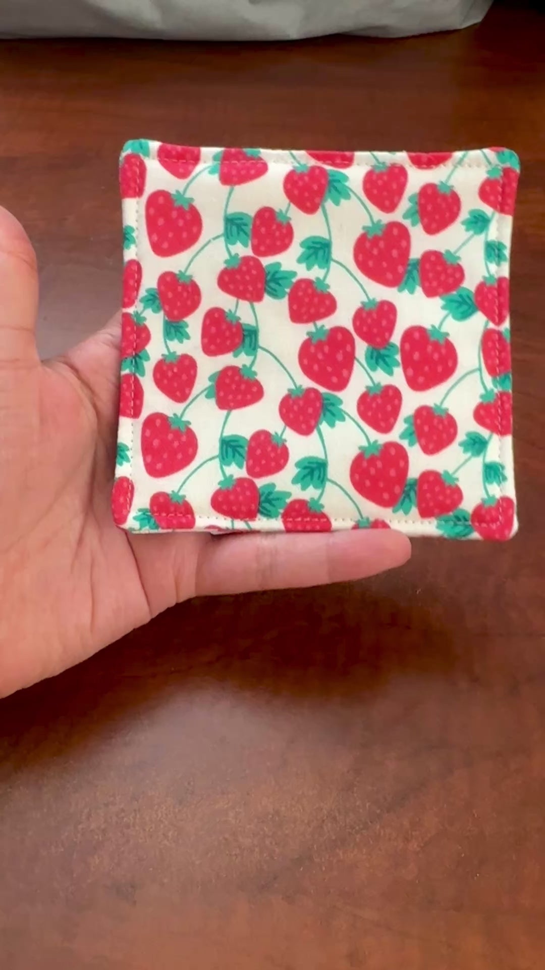 Keep your surfaces safe and stylish with our 100% cotton strawberry coaster. This charming coaster features a vibrant strawberry print that adds a touch of fresh, fruity fun to any room. Crafted with an absorbent cotton batting layer inside, it's designed to soak up condensation and protect your furniture from unsightly water rings and spills. Perfect for coffee mugs, glasses, or teacups, this durable and machine-washable coaster is a delightful addition to your kitchen or living room. Elevate your home dec