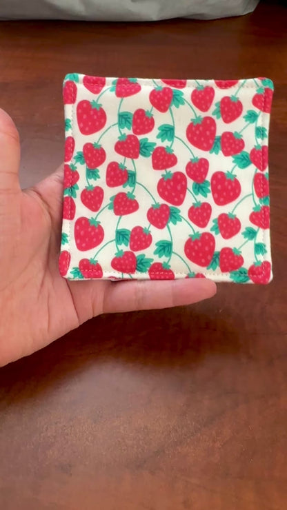 Keep your surfaces safe and stylish with our 100% cotton strawberry coaster. This charming coaster features a vibrant strawberry print that adds a touch of fresh, fruity fun to any room. Crafted with an absorbent cotton batting layer inside, it's designed to soak up condensation and protect your furniture from unsightly water rings and spills. Perfect for coffee mugs, glasses, or teacups, this durable and machine-washable coaster is a delightful addition to your kitchen or living room. Elevate your home dec