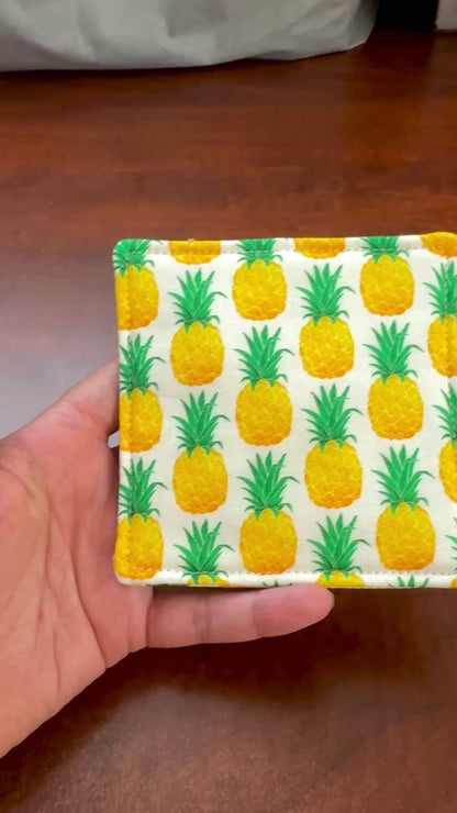 Keep your surfaces safe and stylish with our 100% cotton pineapple coaster. This charming coaster features a vibrant pineapple print that adds a touch of fresh, fruity fun to any room. Crafted with an absorbent cotton batting layer inside, it's designed to soak up condensation and protect your furniture from unsightly water rings and spills. Perfect for coffee mugs, glasses, or teacups, this durable and machine-washable coaster is a delightful addition to your kitchen or living room. Elevate your home decor