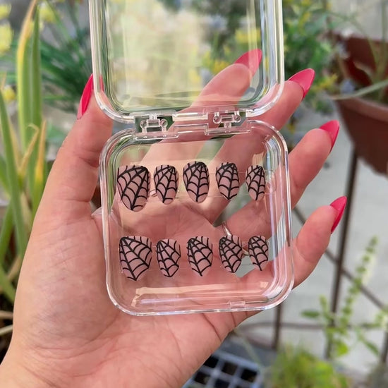 Get ready for "The Nude Weaver" and embrace dark glamour with these stunning handmade press-on nails, featuring a nude base and delicate, black spiderweb design.