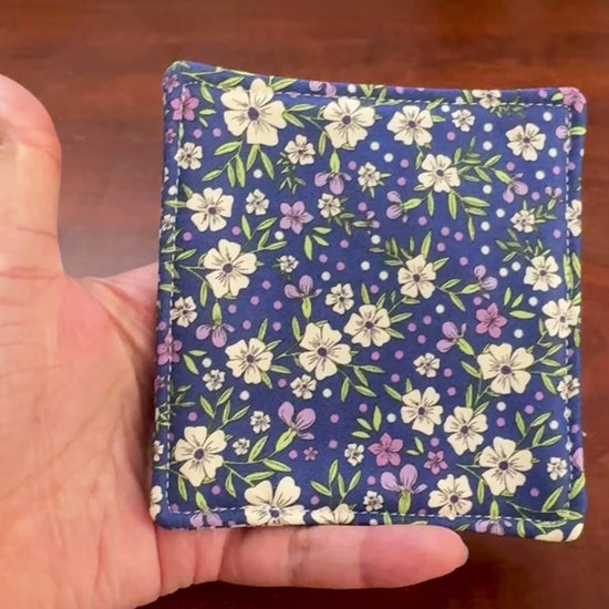 Elevate your space with this playful 100% cotton pink floral coaster. Featuring a vibrant and stylish floral print, this coaster brings a touch of floral and fun to your home. Crafted with an absorbent cotton batting layer inside, it's designed to soak up condensation and protect your furniture from unsightly water rings and spills. Perfect for coffee mugs, glasses, or teacups, this durable and machine-washable coaster is a delightful addition to your kitchen or living room. Elevate your home decor with thi