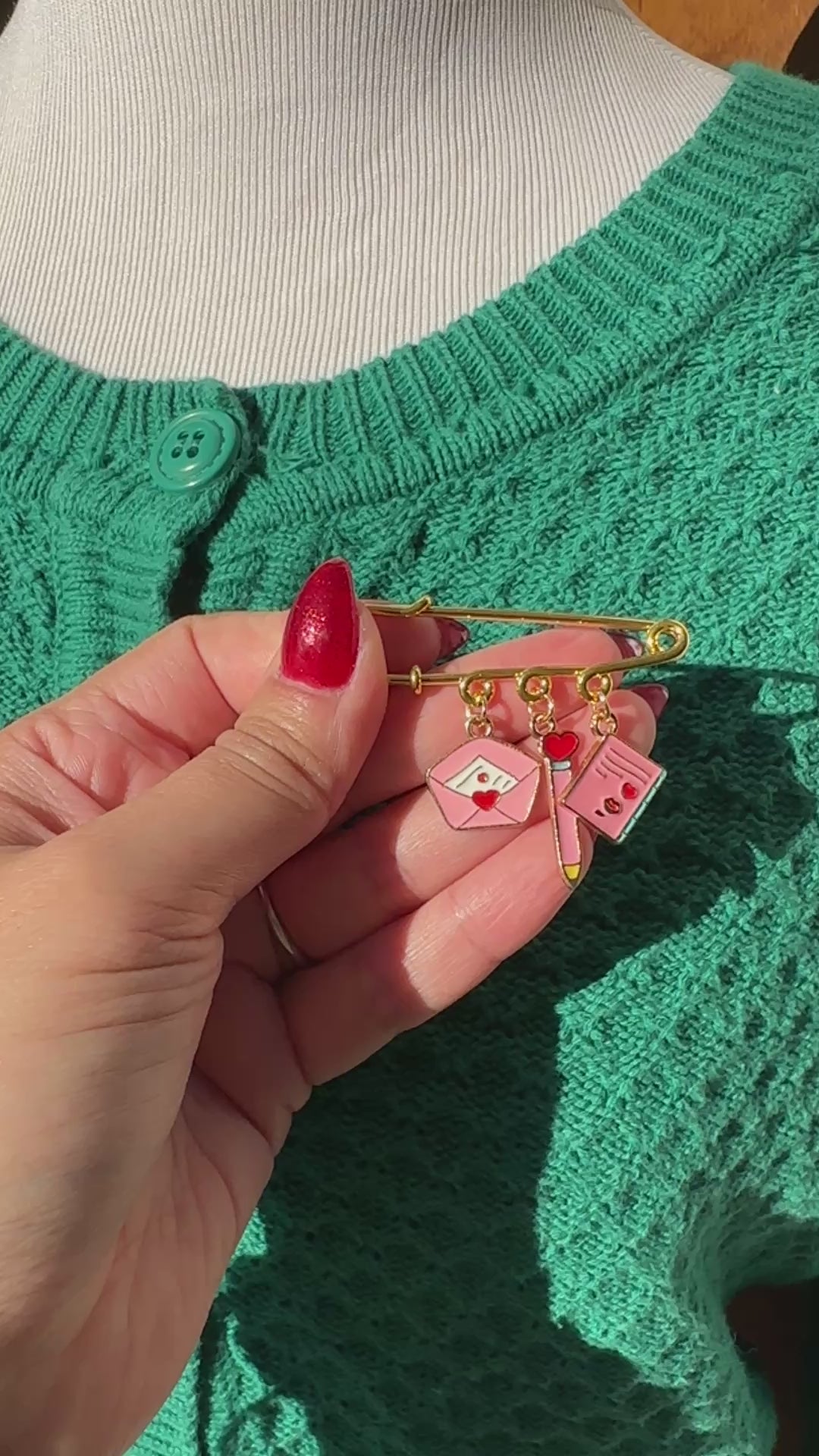 Elevate your Valentines Day or Galentines Day with this adorable gold iron pin brooch featuring love letter enamel charms. Perfect for adding a touch of love to any outfit.