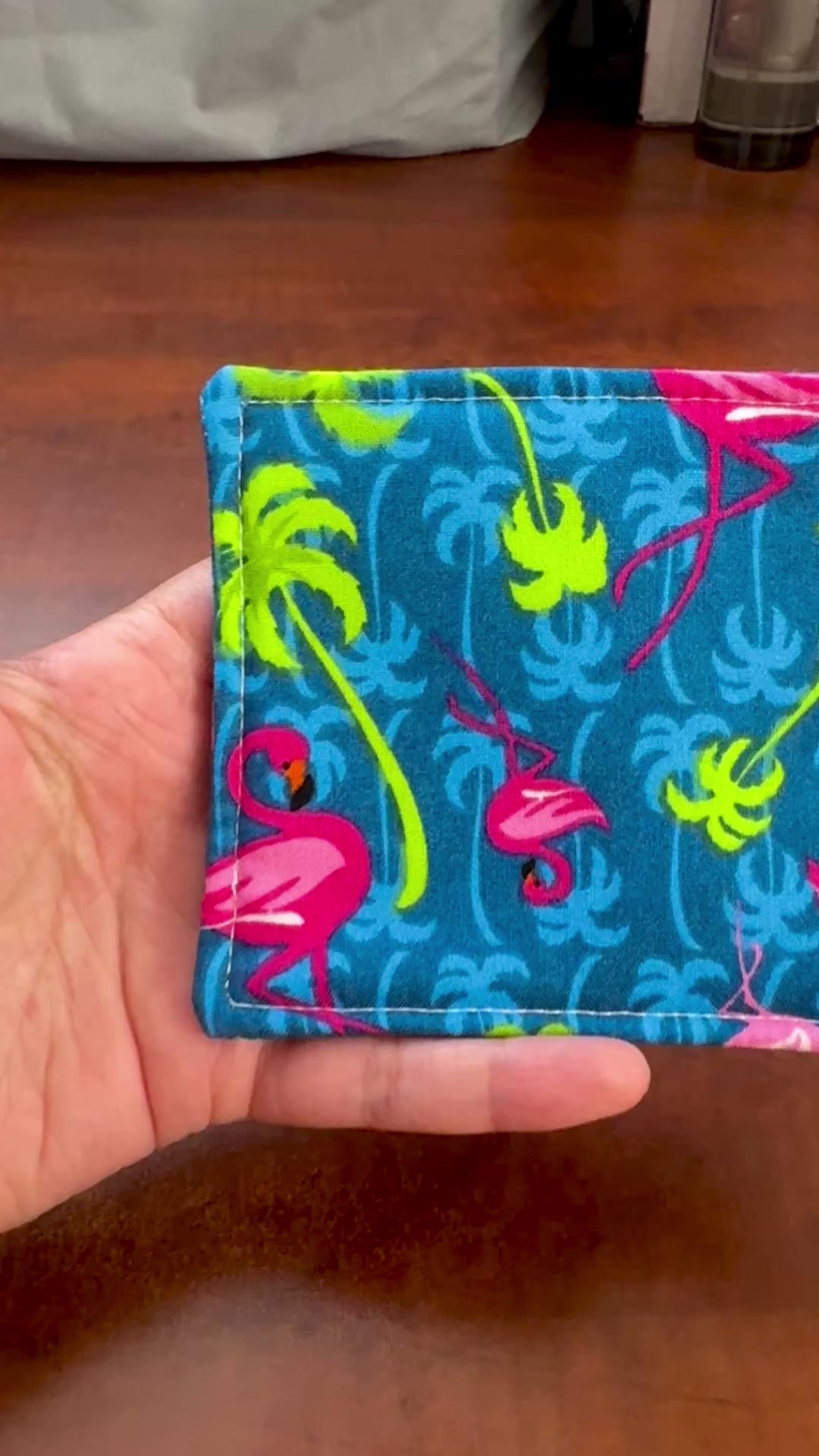 Elevate your space with this playful 100% cotton flamingo coaster. Featuring a vibrant and stylish flamingo print, this coaster brings a touch of tropical flair and fun to your home. Crafted with an absorbent cotton batting layer inside, it's designed to soak up condensation and protect your furniture from unsightly water rings and spills. Perfect for coffee mugs, glasses, or teacups, this durable and machine-washable coaster is a delightful addition to your kitchen or living room. Elevate your home decor w