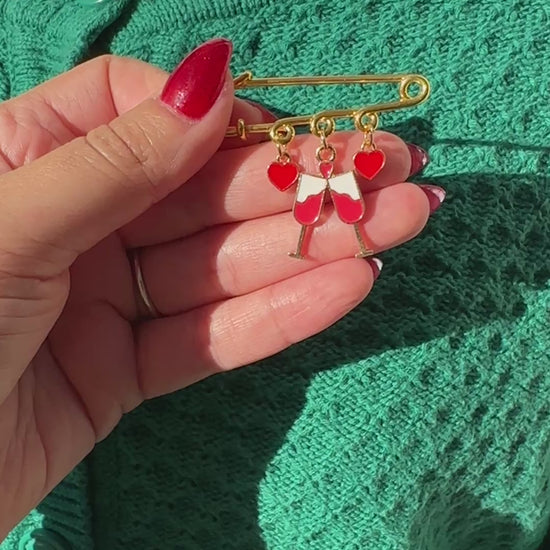 Elevate your Valentine's Day with this adorable gold iron pin brooch featuring drink and heart enamel charms. Perfect for adding a touch of love to any outfit.