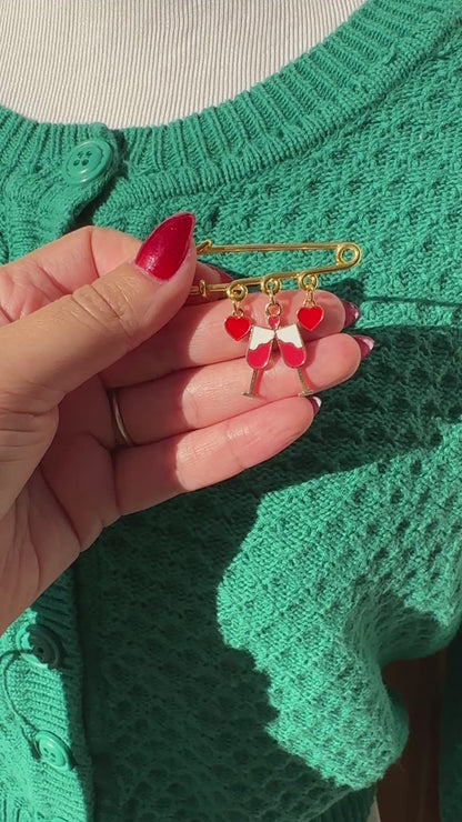 Elevate your Valentine's Day with this adorable gold iron pin brooch featuring drink and heart enamel charms. Perfect for adding a touch of love to any outfit.