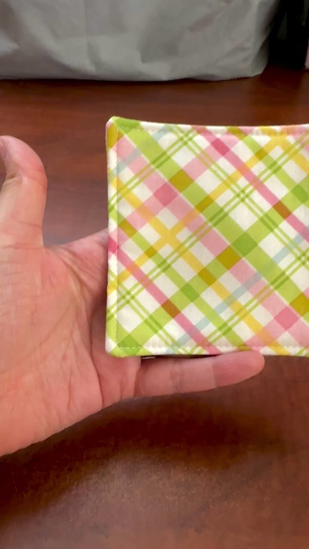 Elevate your space with this playful 100% cotton pink and green plaid coaster. Featuring a vibrant and stylish pink and green plaid print, this coaster brings a touch of retro fun to your home. Crafted with an absorbent cotton batting layer inside, it's designed to soak up condensation and protect your furniture from unsightly water rings and spills. Perfect for coffee mugs, glasses, or teacups, this durable and machine-washable coaster is a delightful addition to your kitchen or living room. Elevate your h