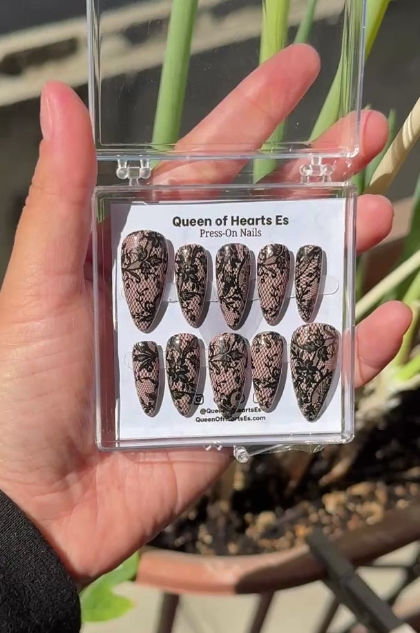 Get ready for "The Seductress" and embrace dark glamour with these stunning handmade press-on nails, featuring a rich nude base and delicate, black lace design.&nbsp;