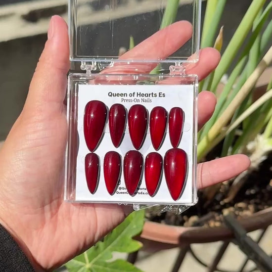 Get ready for "The Romantic" and embrace dark glamour with these stunning handmade press-on nails, featuring a red cat eye base and delicate, reflective design.
