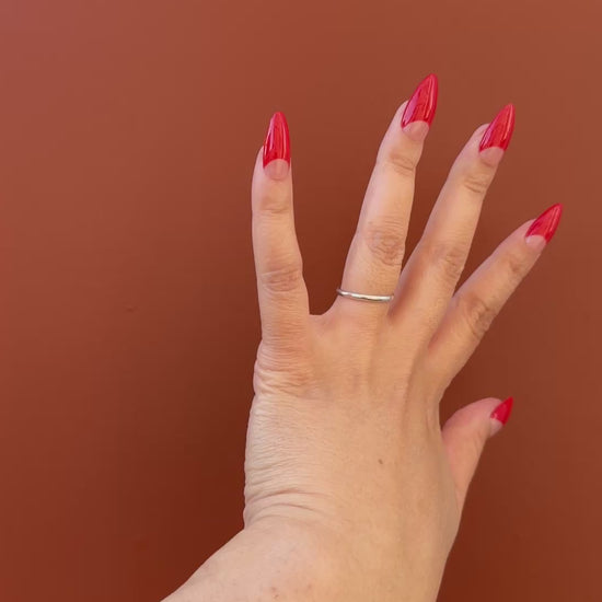 Get ready for "The Red Half Moon" and embrace dark glamour with these stunning handmade press-on nails, featuring a nude base and delicate, red half moon design.