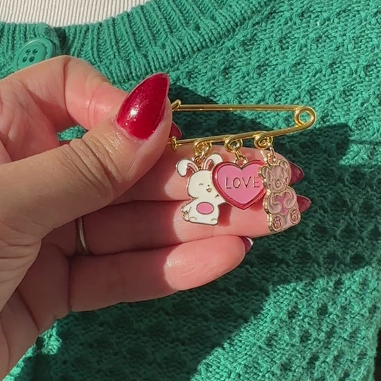 Elevate your Valentines Day or Galentines Day with this adorable gold iron pin brooch featuring a cute stuffed bunny and teddy bear enamel charms. Perfect for adding a touch of love to any outfit.