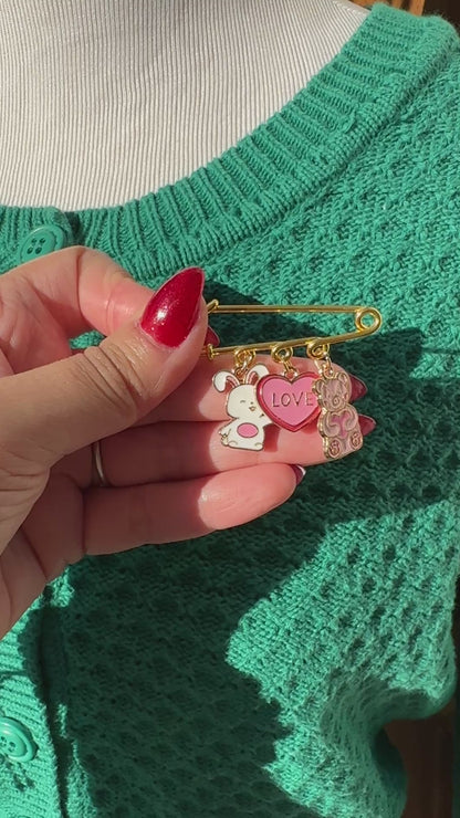 Elevate your Valentines Day or Galentines Day with this adorable gold iron pin brooch featuring a cute stuffed bunny and teddy bear enamel charms. Perfect for adding a touch of love to any outfit.