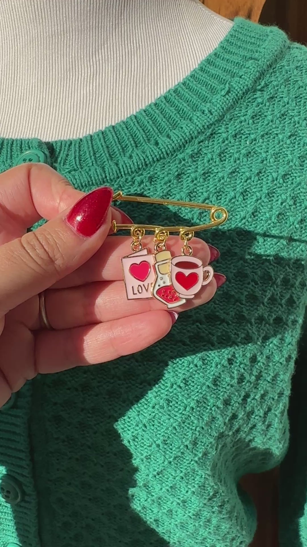 Elevate your Valentines Day or Galentines Day with this adorable gold iron pin brooch featuring love potion enamel charms. Perfect for adding a touch of love to any outfit.