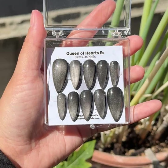 Get ready for "The Apparition" and embrace dark glamour with these stunning handmade press-on nails, featuring a silver cat eye base and delicate, reflective design.